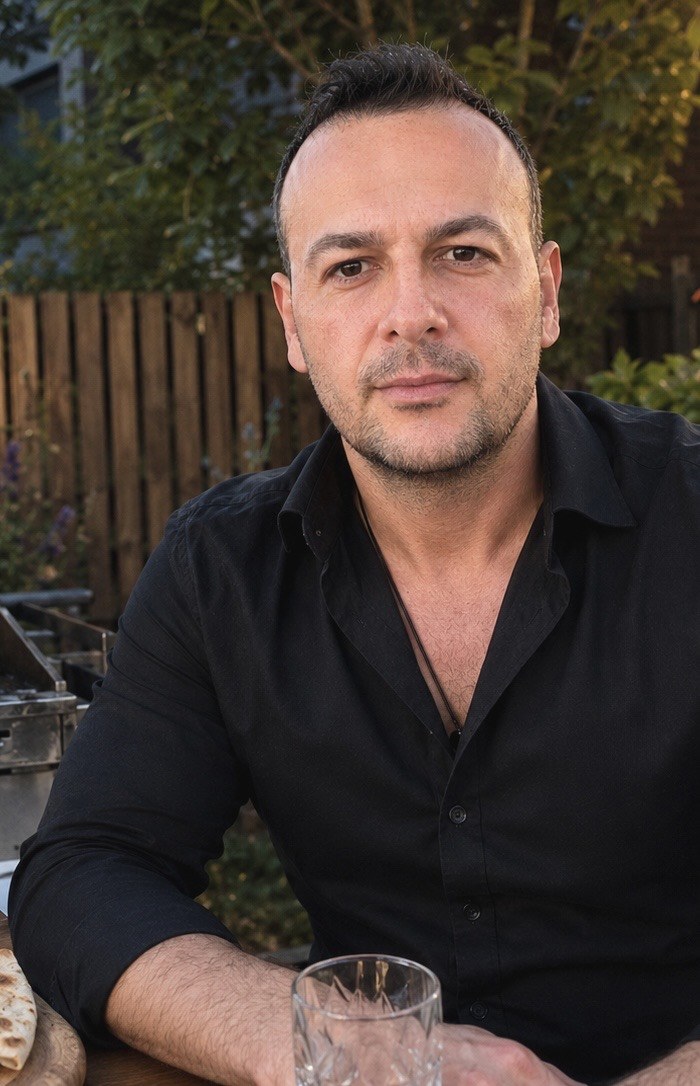 Yusuf Baykal Bozkurt in a black shirt, relaxed portrait